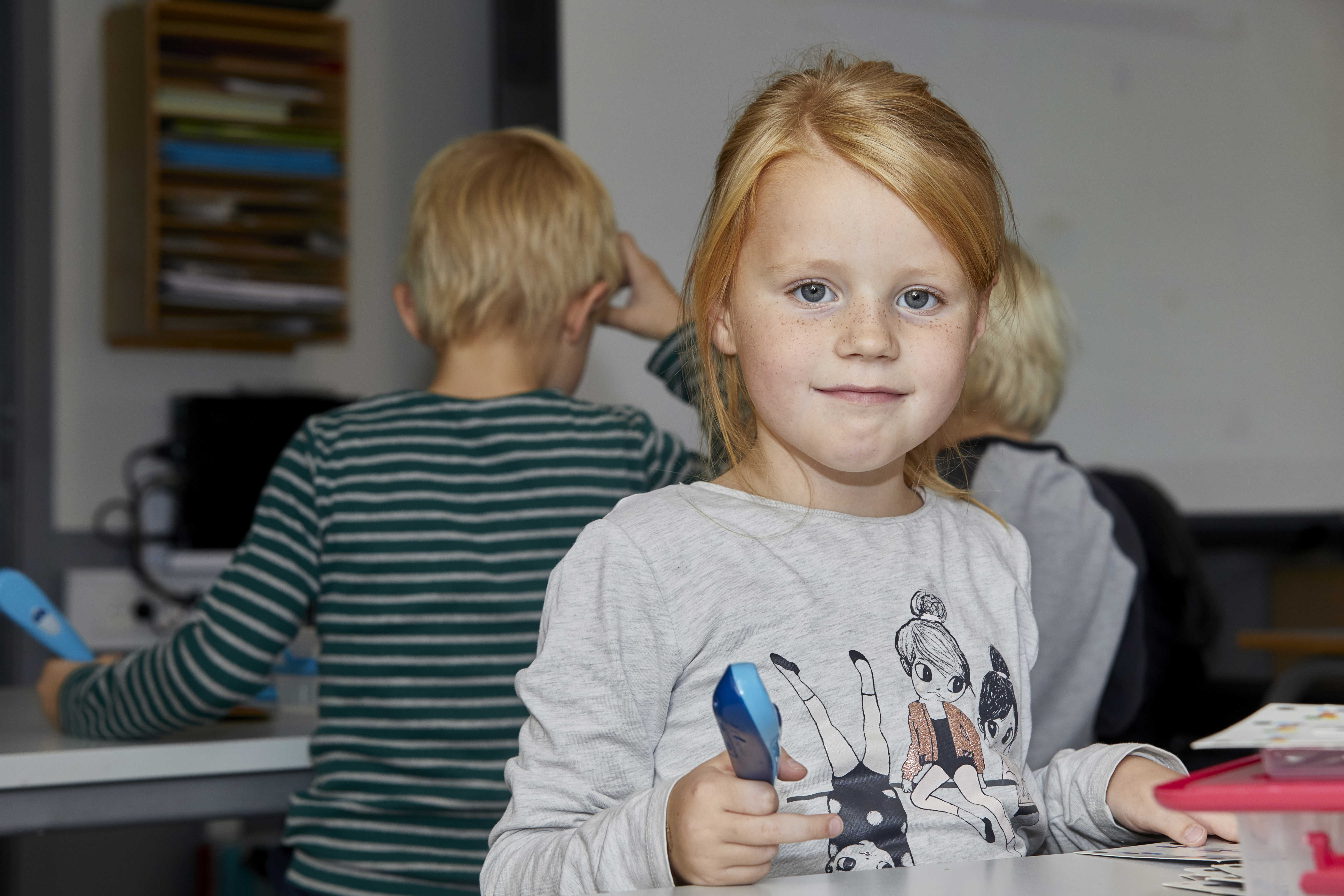 Pige sidder i klasselokale